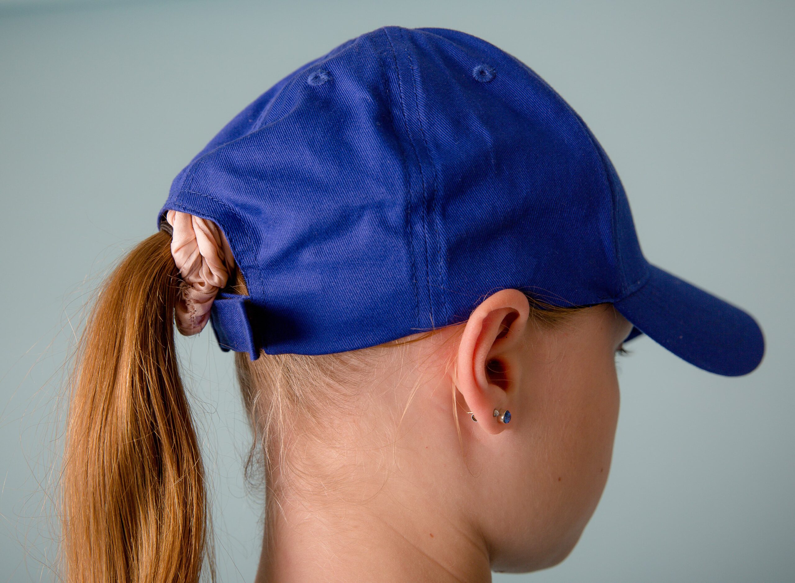 NKMA Blue Baseball Cap - Close up Rear of female model