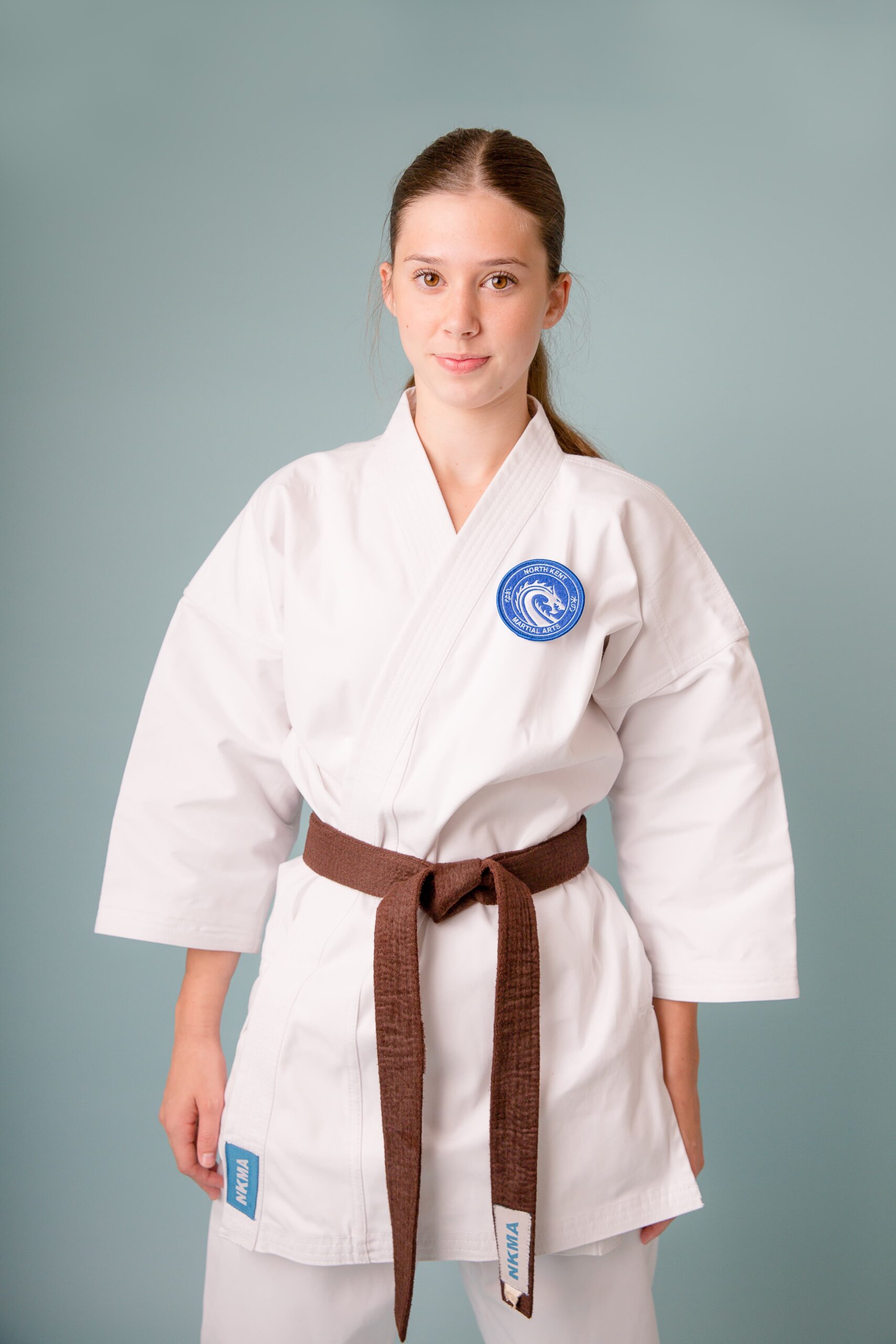 NKMA Premium Heavy Weight Gi - front on female model with brown belt